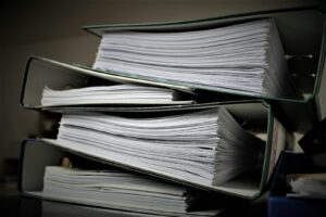 Close-up of stacked binders filled with documents for office or educational use.